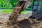 Close up view of medium size bulldozer levels recently dumped earth