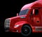 Close-up view of metallic red fuel cell powered American truck on black background