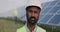 Close up view of mixed raced male engineer in hard helmet looking to camera. Bearded serious man in uniform standing at