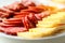 close-up view of a mouthwatering antipasto catering platter featuring a delectable assortment of sausage, cheese, bacon