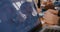 Close-up view of multiethnic team working together behind office table, woman speaking is seen in screen reflection.