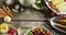 Close up view of multiple food ingredients and vegetables on wooden surface