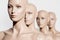 close-up view of naked bald mannequins in row on white,