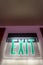 Close up view of a neon green light Exit sign inside a building