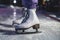 Close up view of new white ice skates boots on rink in motion, girl ice skating on arena, concept of ice skating in winter,