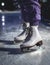 Close up view of new white ice skates boots on rink in motion, girl ice skating on arena, concept of ice skating in winter,