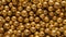 Close-up view of numerous reflective golden spheres packed tightly