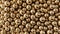 Close-up view of numerous reflective golden spheres packed tightly