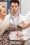 Close-up view of a nurse putting a blood pressure monitor on a fifty-year-old patient. Doctor's office