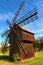 Close-up view of old wooden windmill. Blue sky in the background.