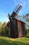 Close-up view of old wooden windmill. Blue sky in the background