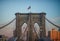 Close up view of one of the towers structures of the brooklyn bridge, flying the Stars and Stripes on the top