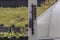 Close up view of outdoor thermometer on white wooden pillar.