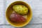 Close up view of pair of red a yellow indian figs also called prickly pear inside a bowl