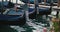 Close-up view of parked gondolas bobbing on water of the Venetian canal