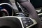 A close-up view of a part of the interior of a modern luxury car with a view of the gearshift paddles made of chrome with the