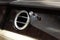 A close-up view of a part of the interior of a modern luxury car with a view of the ventilation chrome round deflector of the