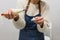 Close up view of a pastry chef filling macaroons with pastry bag while working in the pastry kitchen.