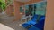 Close-up view of on patio hotel room with sun loungers backdrop of reflections in window overlooking Atlantic Ocean.