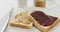 Close up view of peanut butter and jelly sandwich in a plate with copy space on white surface