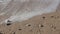 Close-up view of the pebbles, sand and waves at the beach