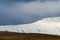 Close up view of pen y fan brecon during winter season with snow on the peak of the mountain with many walkers enjoying