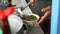 Close-up view of a penjual mie ayam bakso or meatball chicken noodle seller who is making chicken noodles for the buyer. Selective