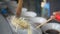 Close-up view of a penjual mie ayam bakso or meatball chicken noodle seller who is making chicken noodles for the buyer. Selective