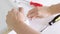 Close up view of a person assembling new white drawer using a screwdriver, tighten a screw with a hex allen key