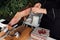 Close-up view of a person hand cutting a slice of traditional spanish iberian ham.