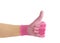 Close up view of person hand wearing vibrant color pink gardening working glove and showing thumb up like gesture.