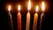 Close-up view of person lighting birthday candles with match