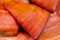 Close up view of piece cold smoked salted Pacific red fish Chinook Salmon. Prepared, ready-to-eat Pacific seafood. King