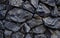 Close-up view of a pile of coal with a rough, irregular shape and texture.