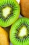 Close up view of a pile of kiwi fruits, whole and halves