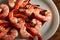 Close-up view of the pile of marinated shrimps over the white plate