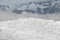 A close-up view of a pile of snow on a mountain background