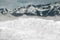 A close-up view of a pile of snow on a mountain background