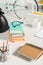 close up view of piles of books, notebooks, folders, cup of coffee and eyeglasses at workplace