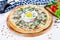 Close up view on pizza on white wooden background with ingridients. Italian cuisine.