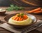 Close-up view plate of mashed potatoes with cooked carrots on brown wooden table