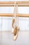 Close up view of pointes for ballet hanging on barre