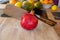 Close-up view of a pomegranate and a cleaver on a wooden cutting board