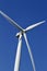 Close up view of the propellers on a giant wind power turbine with blue sky background