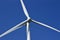 Close up view of the propellers on a giant wind power turbine with blue sky background