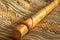 Close up view of a rain stick on a Peruvian textile. Andean music concept