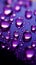 Close up view of raindrops on a window, kissed by purple light