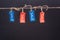 Close-up view of red and blue sale tags hanging on rope isolated on black