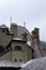 Close up view of red tile roofs under snow in ancient Bran Castle. Also called Dracula`s Castle.