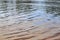 Close up view on a reflective water surface with waves and ripples in high resolution